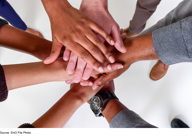 An image of hands gathering in the center.